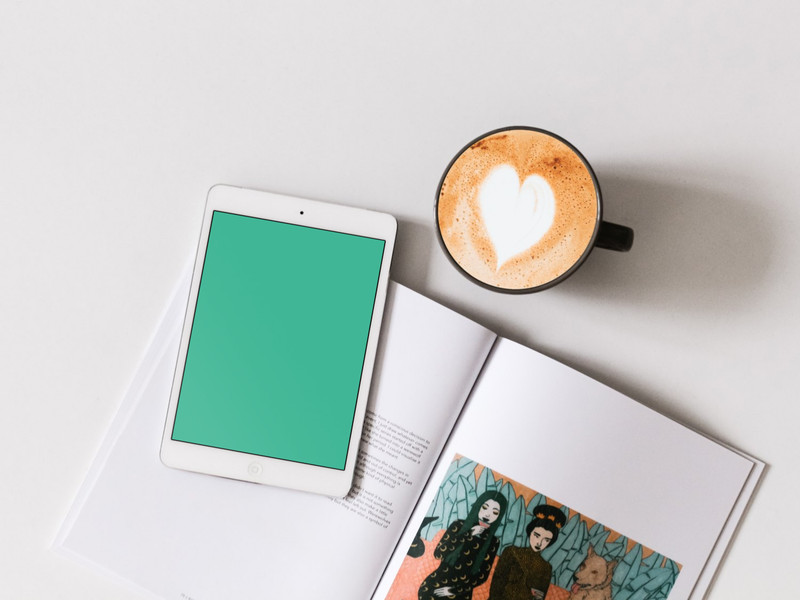 White iPad with coffee and book