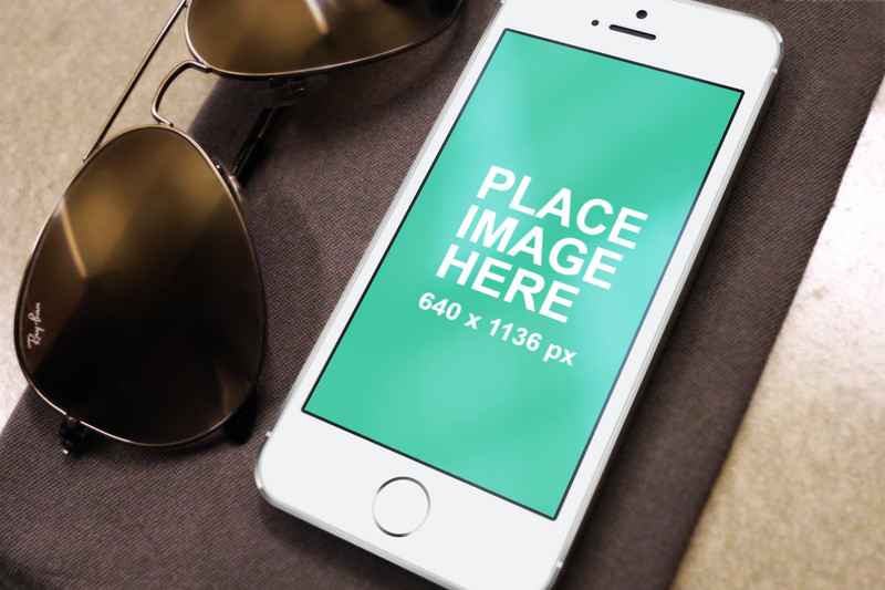 White iPhone and sunglasses